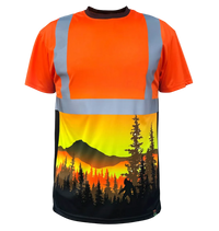 A short-sleeve high-visibility safety shirt with reflective silver-gray stripes on an orange body, featuring a large scenic graphic print of a mountain and pine forest sunset on the lower half.